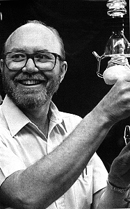 Professor Gaines holds a piece of chemical equipment.